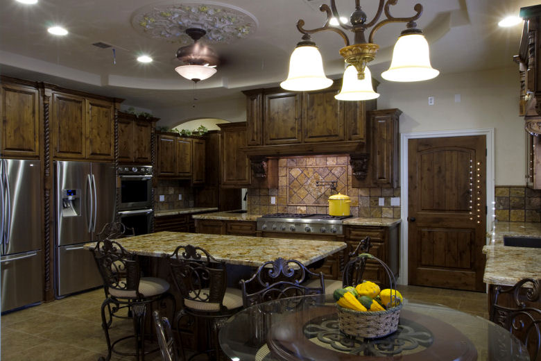 Custom Mediterranean-style kitchen cabinetry with a center island built by Caldwell Enterprise